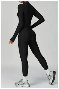 Close-up of ribbed texture on slim fit high neck yoga jacket and leggings in black