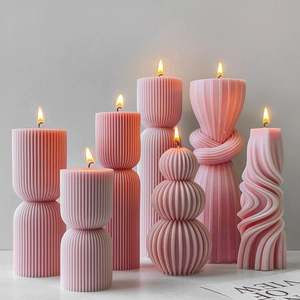 Pink pillar scented candles in striped and geometric shapes for home decor and aromatherapy