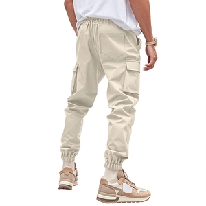 Detail of men's loose cargo pants with large flap side pockets and elastic ankle cuffs