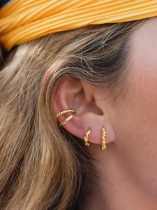 Detailed close-up of 18k gold plated twisted rope C-shaped hoop earrings and ear cuff