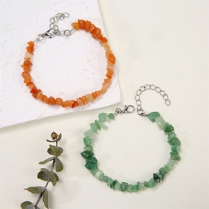 Detail of natural crushed stone bracelets with orange and green stones and lobster clasp