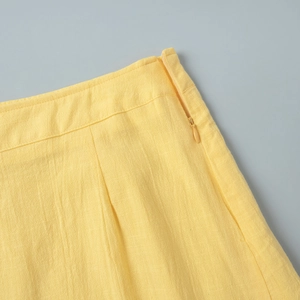 Detailed macro view of yellow cotton linen skirt featuring side invisible water drop zipper