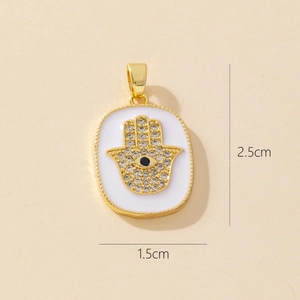 Gold Hamsa Hand pendant with zircon and evil eye, measuring 2.5cm by 1.5cm in size