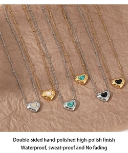 Flat lay of heart-shaped natural stone necklaces in gold and silver finishes on textured paper