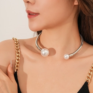 Close-up of elegant silver spring neck wire with two white pearls on model neckline