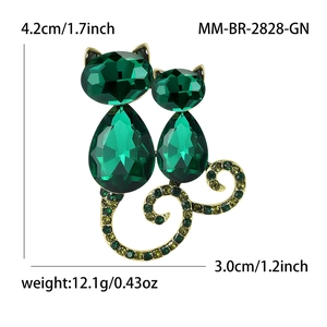 Elegant gold-tone cat brooch with green crystals and size specs on a white background