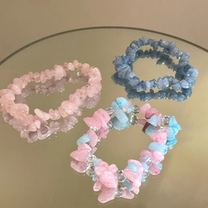 Close-up of aquamarine and pink crystal elastic bracelets with stone textures