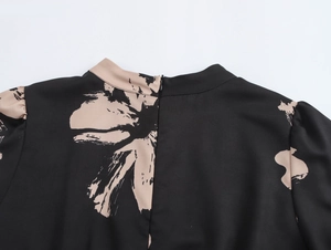 Close-up of floral print dress back featuring a hidden zipper and premium fabric texture