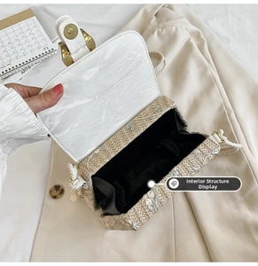 Detail showing the internal structure of the straw crossbody bag with marble leather flap