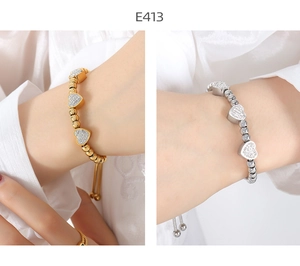 Detail view of heart-shaped beaded bracelets in gold and silver plating with rhinestones