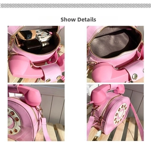 Detail of pink retro telephone bag showing interior space and heart dial pattern