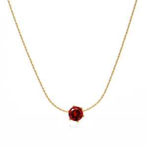 Minimalist gold necklace with a round red zircon in a six-prong setting on white background