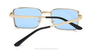 Detail view of square metal sunglasses with light blue lenses and golden frame