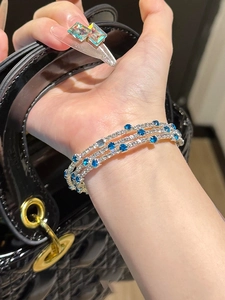 Close-up of triple-layer silver bracelet with deep blue and white sparkling crystals