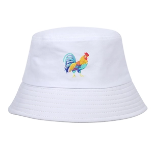 Close-up of colorful rooster embroidery on white cotton bucket hat with stitching detail