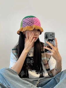 Detailed view of handmade crochet knit bucket hat with bohemian multi-color flower patterns