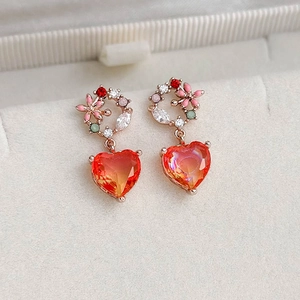 Elegant rose gold flower earrings with heart-shaped orange zircon stones and crystal accents