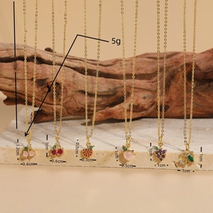 14K gold plated brass necklaces with colorful zircon fruit pendants in a luxury display