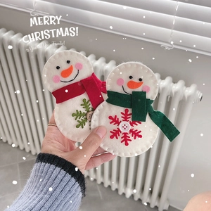 Handmade felt snowman ornaments with red and green scarves for Christmas tree decoration