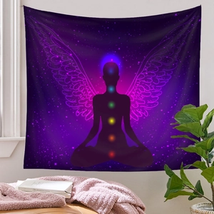 Detail of meditation tapestry with 7 chakra points and wings on a cosmic star background