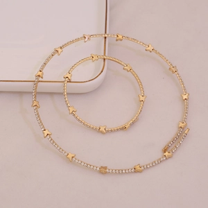 Elegant gold rhinestone choker and bracelet set featuring minimalist butterfly accents