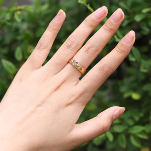 Close-up of 18k gold plated ring with a square zircon gemstone on a woman's finger