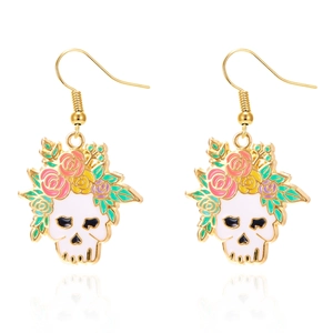 Close-up of Halloween skull earrings with colorful enamel flowers and golden hooks