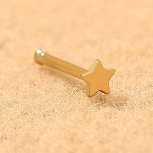Close-up of a single gold star-shaped stainless steel stud earring with a polished finish