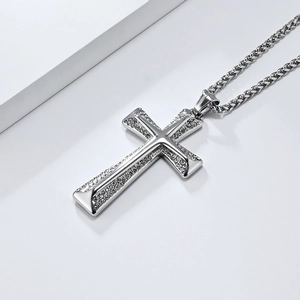 Macro shot of silver cross pendant with sparkling zircons on a durable Cuban link chain