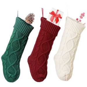 Three 46cm knitted Christmas stockings in green, red, and white with classic cable pattern