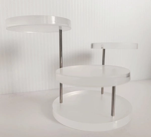 Detail of three-tier white acrylic jewelry display stand with silver metal support rods