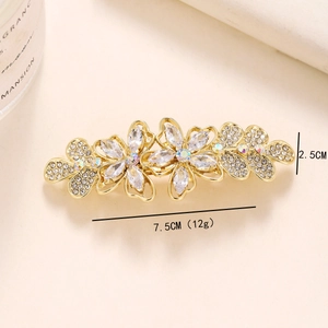 Golden flower hair clip with pearls and sparkling zircons in a horizontal floral design