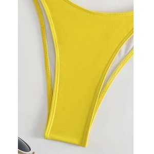 Close-up of bright yellow high-cut bikini bottom with double-stitched edges and smooth fabric