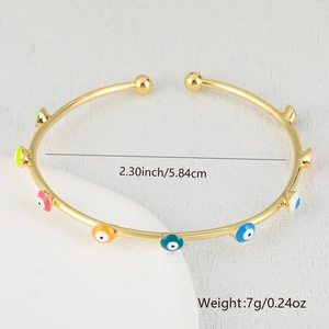 Detail shot of golden evil eye bangle showing 5.84cm diameter and colorful enamel motifs