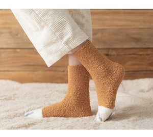 Detailed close-up of brown coral fleece socks with cute grey cat paw pattern design