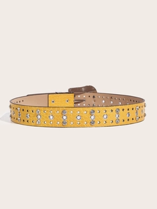 Detail of yellow PU leather belt featuring crocodile texture and star cutouts with rhinestones