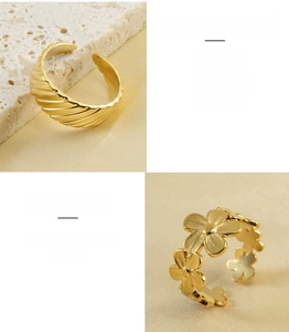 Close-up of 18k gold plated stainless steel ribbed and floral adjustable open rings
