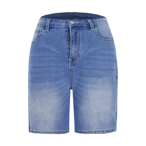 Detailed macro view of washed denim texture and five-pocket design on blue capri jeans
