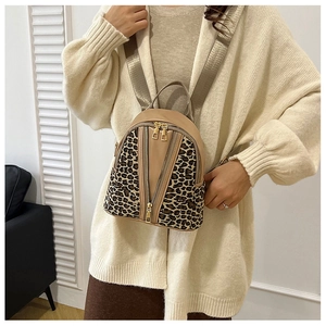 Detail of khaki mini backpack with leopard print panels and adjustable wide strap
