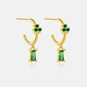 Detail of S925 silver gold earrings with green clover and radiant cut zircon pendants