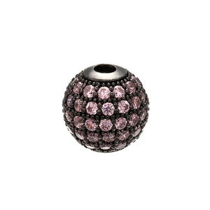 Detailed macro view of a black micro-pave bead with pink crystals for DIY jewelry making