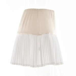 Detail view of the beige elastic top and white pleated hem on this stylish mini skirt