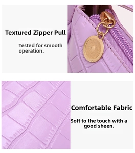 Detail of purple croc-embossed leather with a premium smooth golden metal zipper pull
