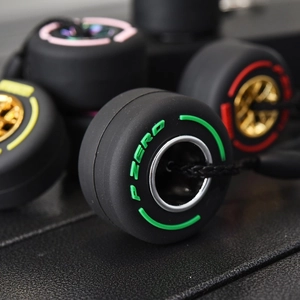 Miniature P ZERO tire keychain with colorful hub rim and high-detail rubber texture