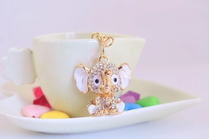 Detailed close-up of a sparkling gold elephant keychain with rhinestones and enamel accents