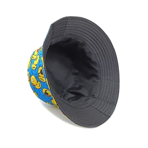 Reversible bucket hat featuring black canvas and blue fabric with yellow duck patterns