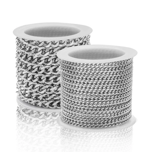 Macro shot of silver Cuban link chains on white spools for DIY jewelry making