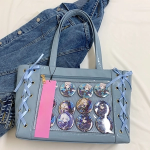 Detail view of light blue ita bag with clear window and ribbon lace-up decoration