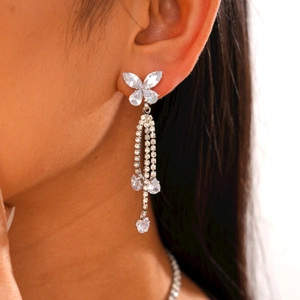 Close-up of silver butterfly fringe earrings with shimmering zircon waterdrop pendants