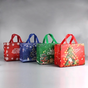 Set of four non-woven Christmas gift bags featuring festive Santa and snowflake prints
